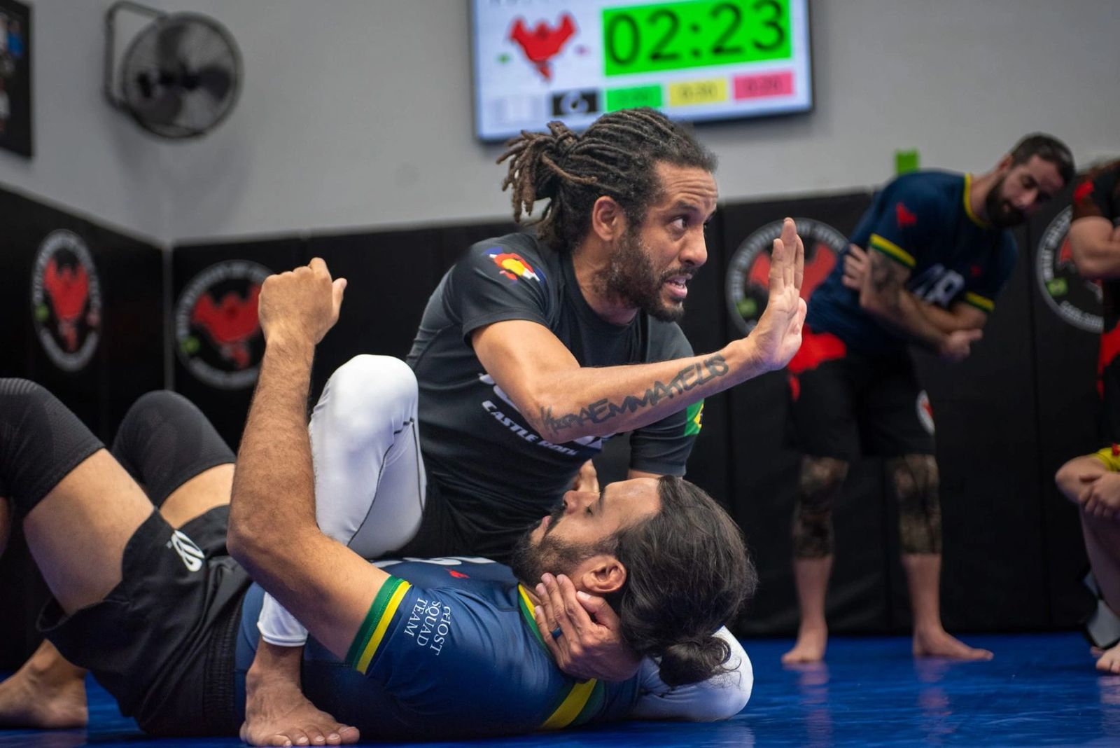 Master Buiu coaching students during a no-gi training round