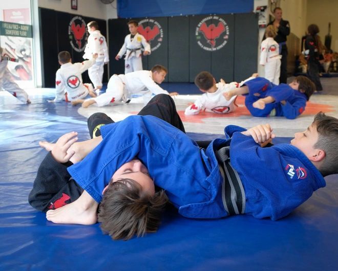Kids class training together on the mats